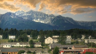 photo of a town with a mountain range in the background
