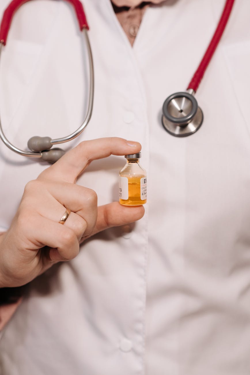 close up photo of a person holding a vaccine in a vial