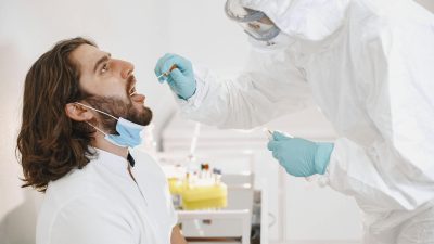 a medical professional doing a swab test on a patient