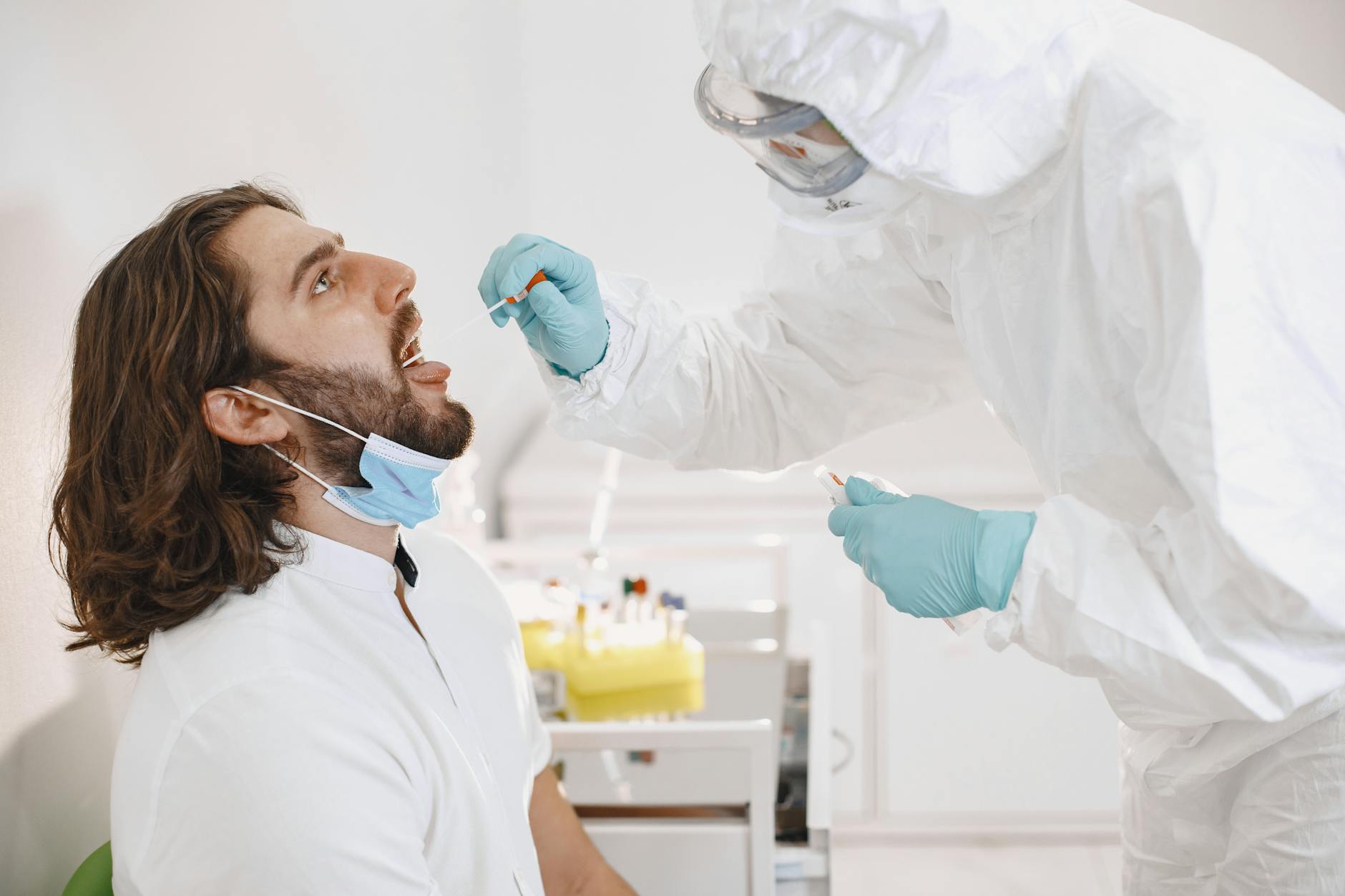 a medical professional doing a swab test on a patient