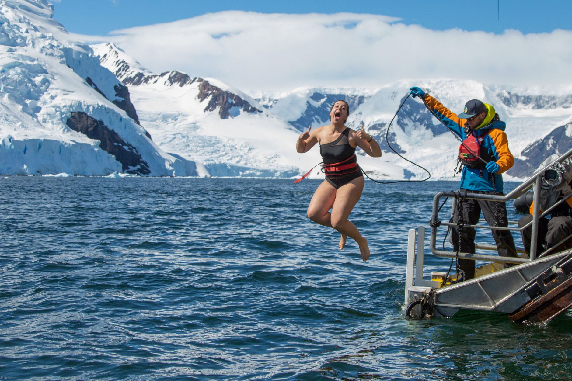 woman in black swimsuit jumping on water