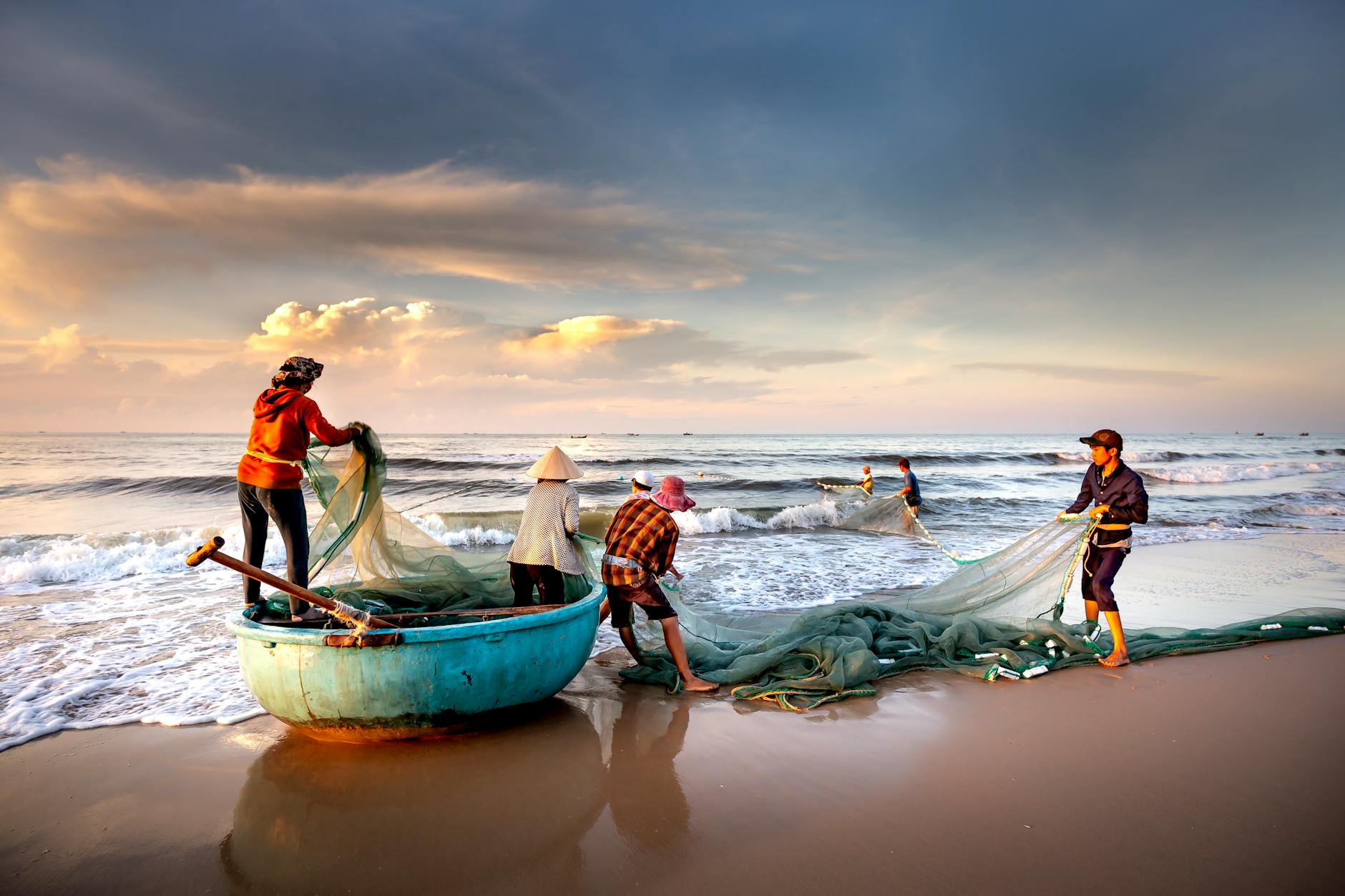 fishermen fixing nets on the seashore