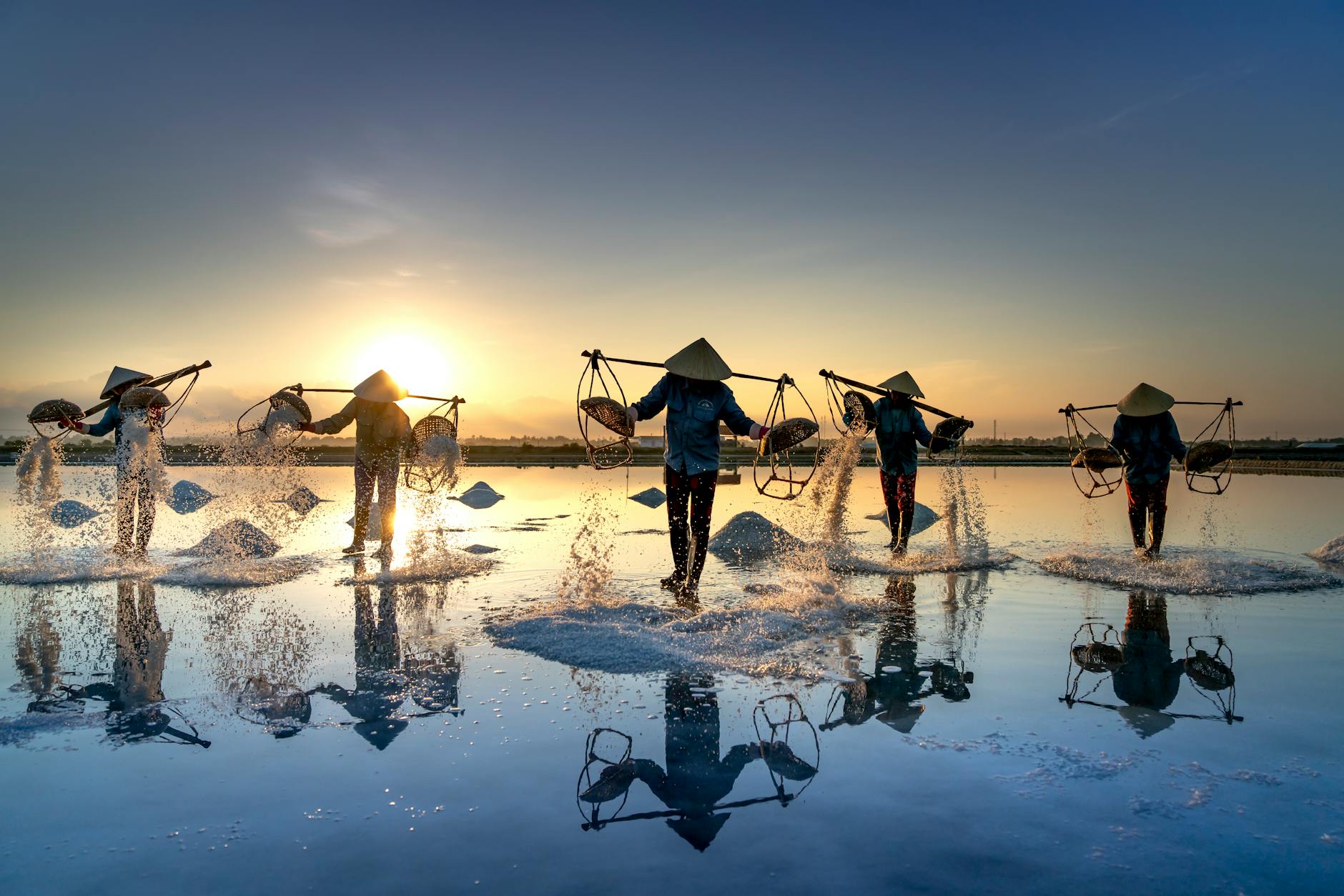 people working in a salt field at hon khoi vietnam