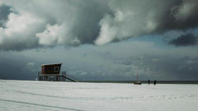 lonely house on snowy seashore