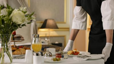 person serving order on hotel room service