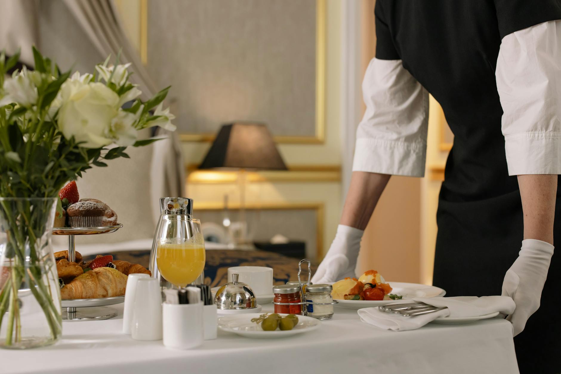person serving order on hotel room service