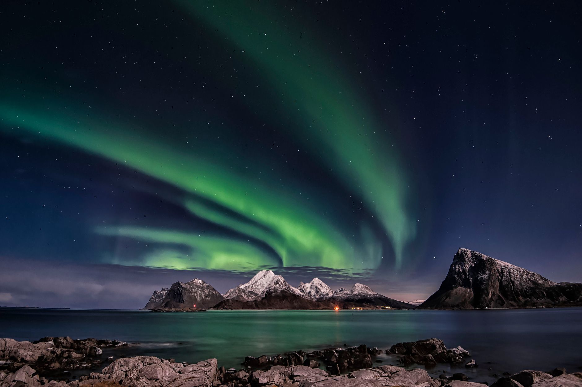 the northern lights above mountains
