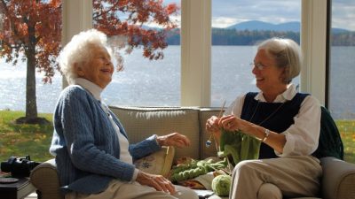 elderly woman sitting on sofa while having a conversation