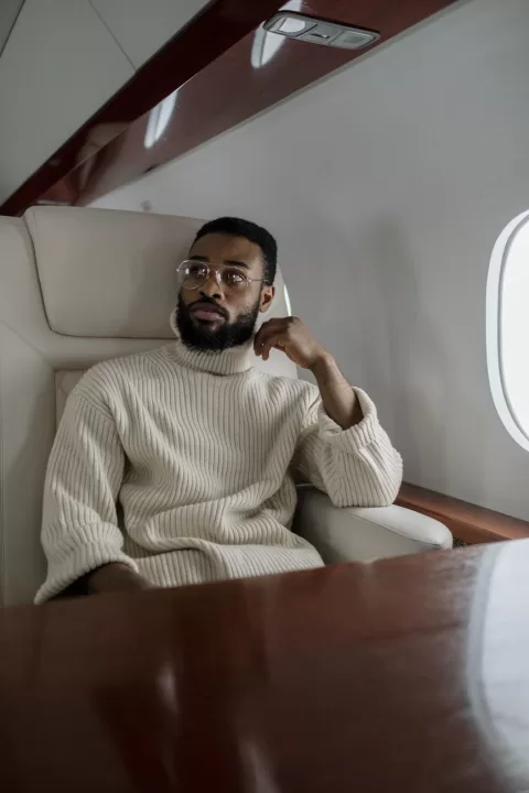 a man in beige turtle neck sweater