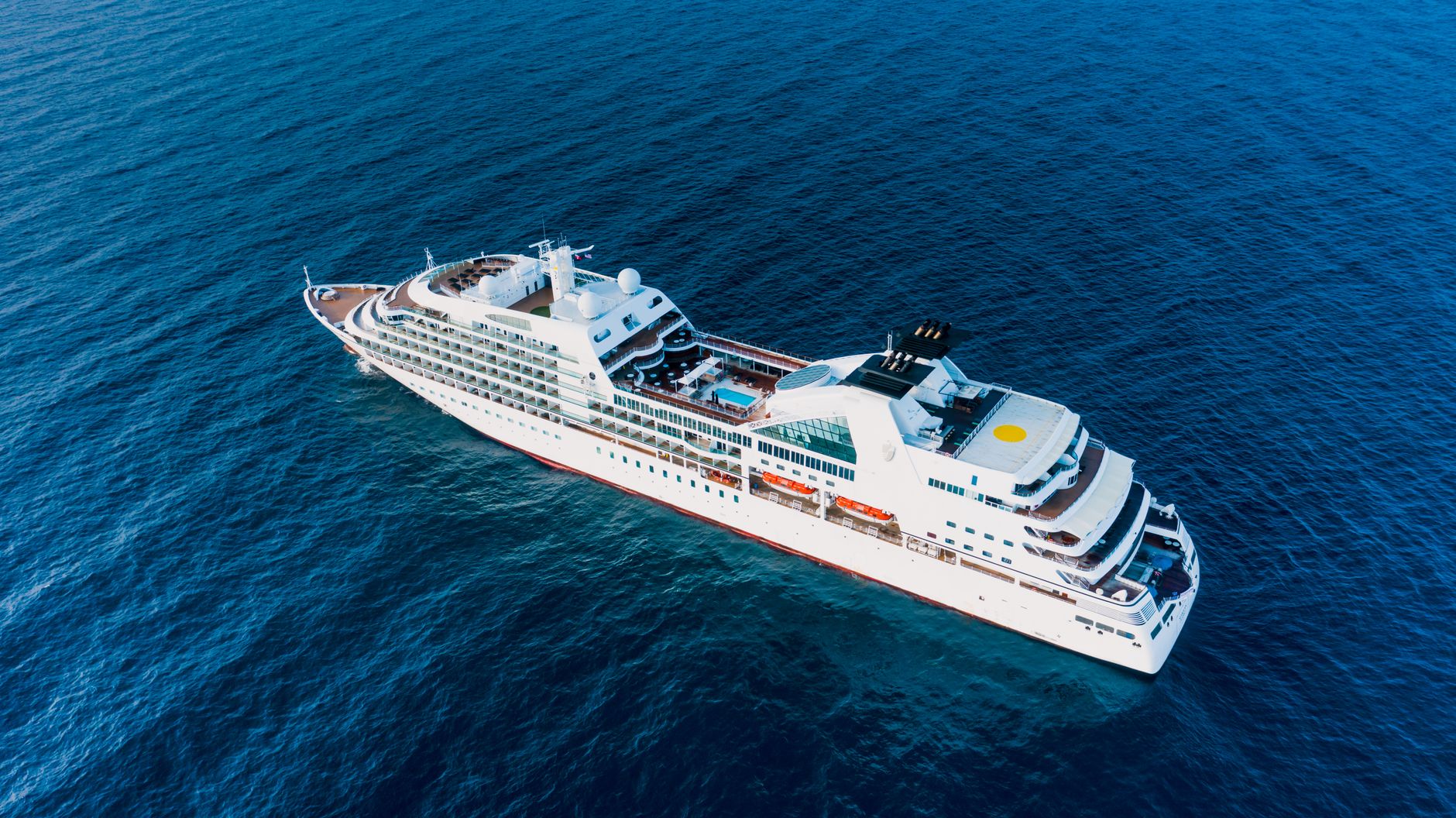 cruise ship floating on blue sea in sunny day