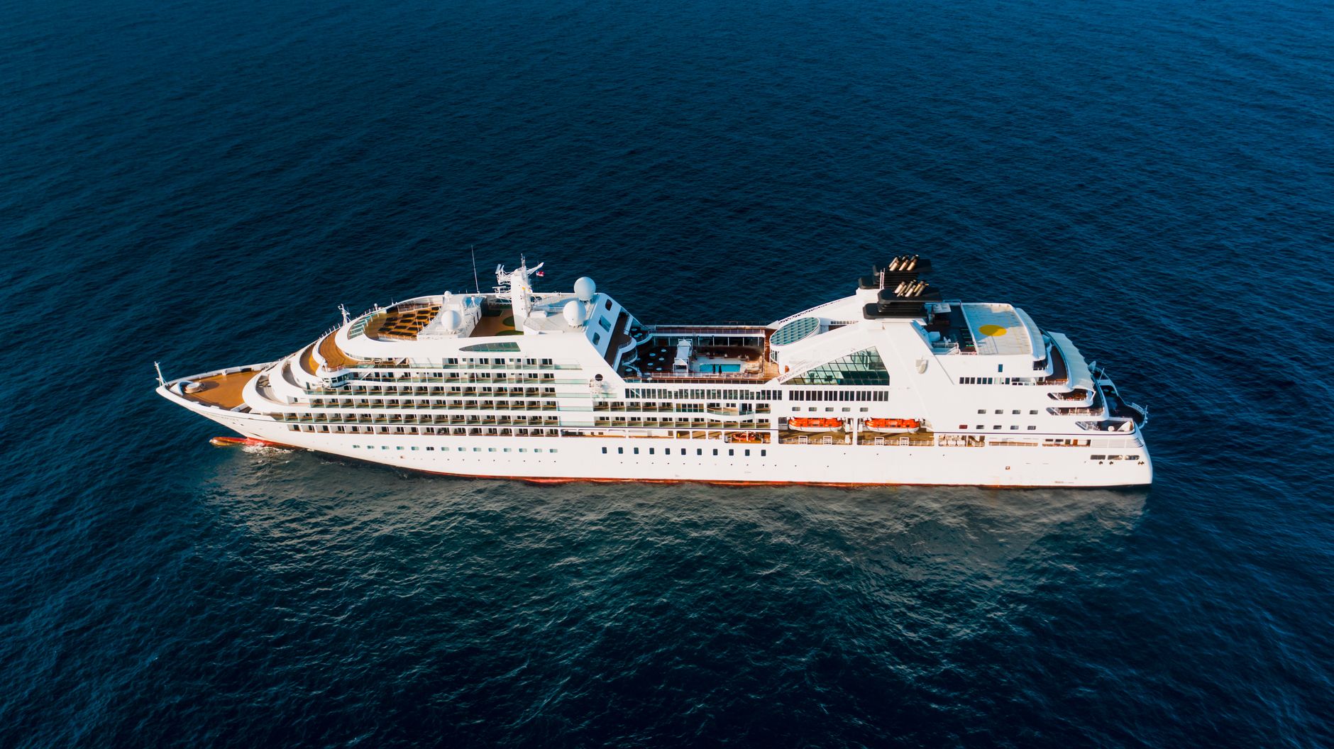 modern cruise ship sailing in sea in sunlight