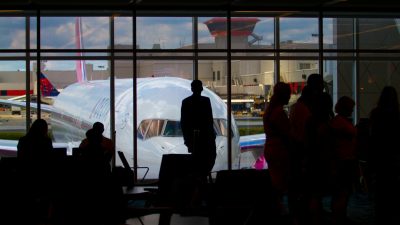 silhouettes of people near an airplane