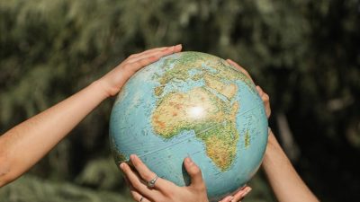 people holding a globe