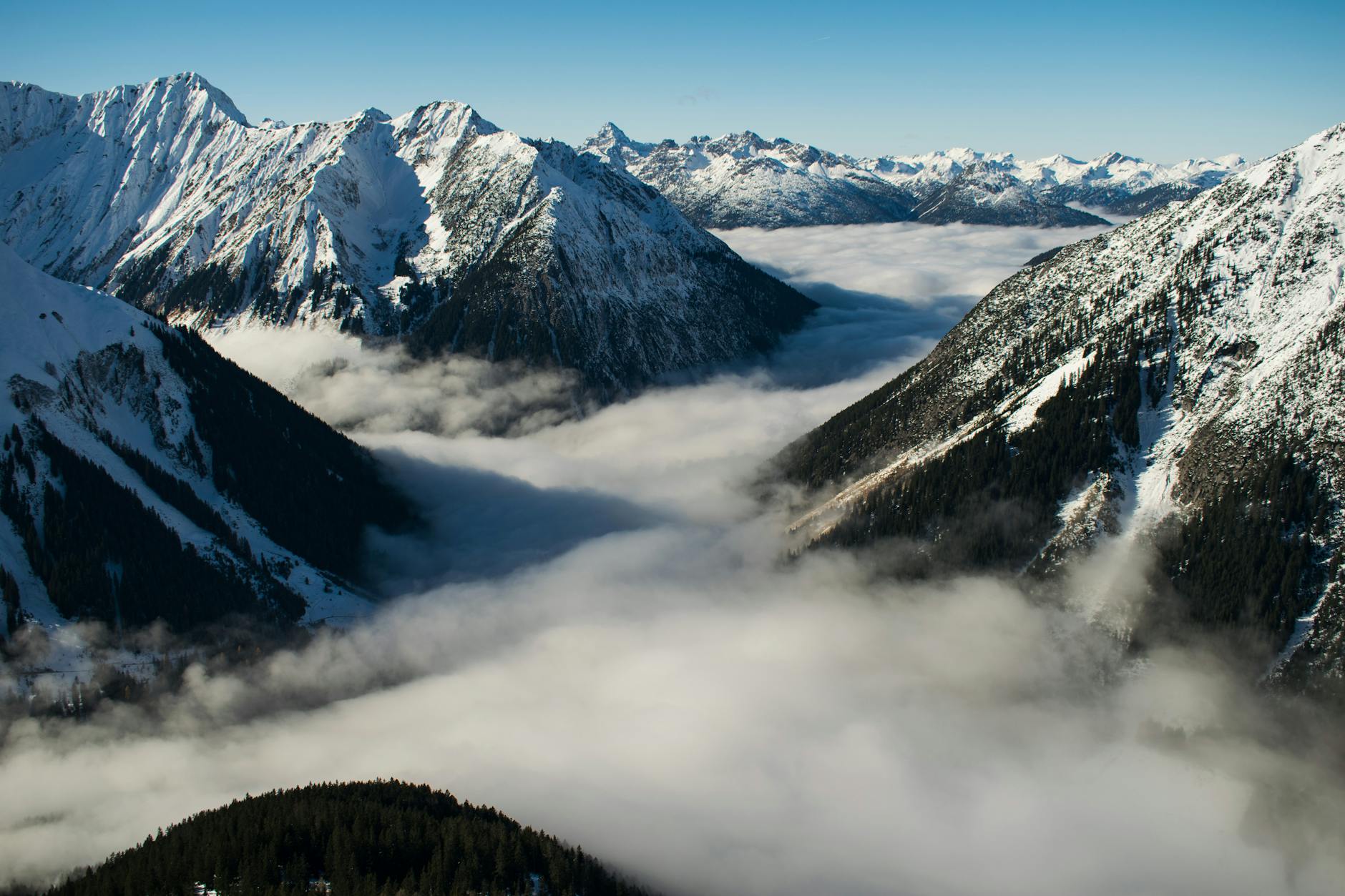 rocky mountain with fog in daytime photo