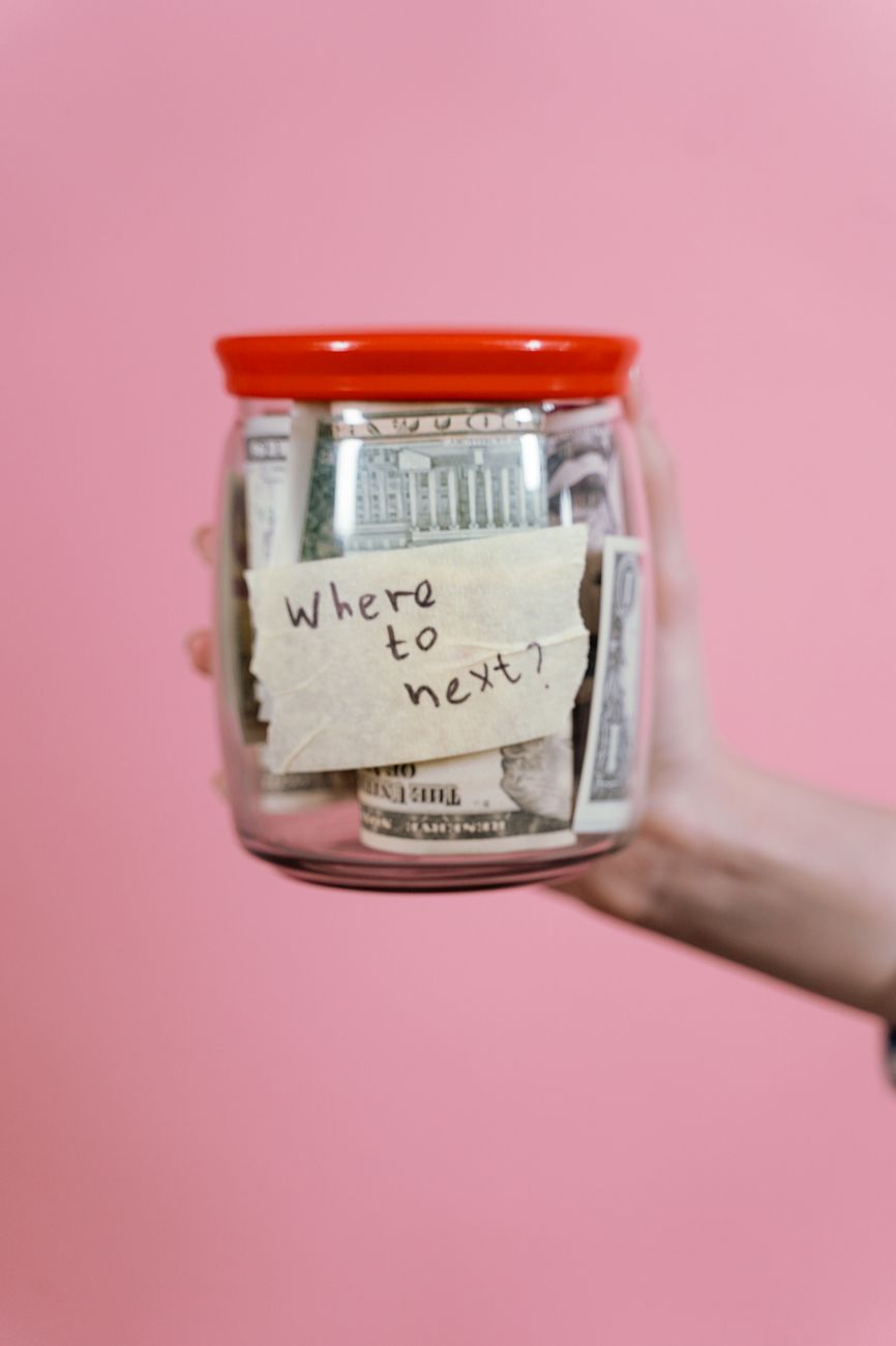 jar full of money held by a person