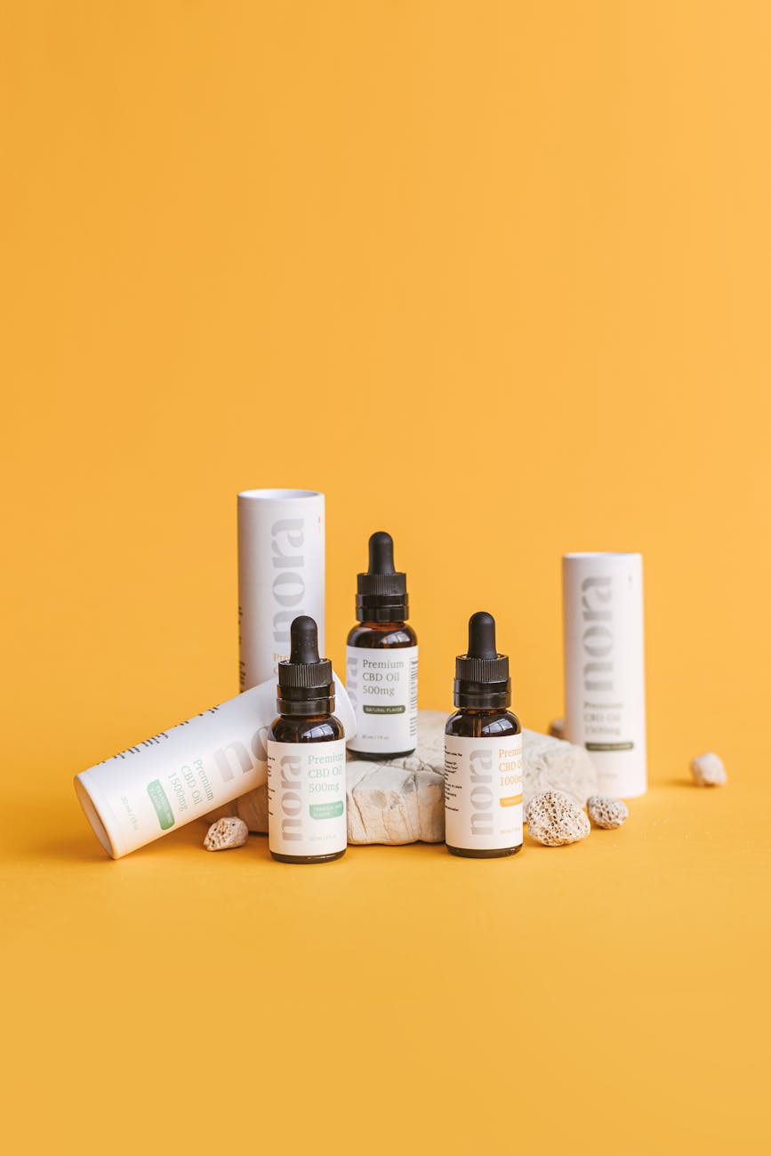 cannabid oil based cosmetic products on yellow surface