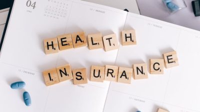 health insurance scrabble tiles on planner