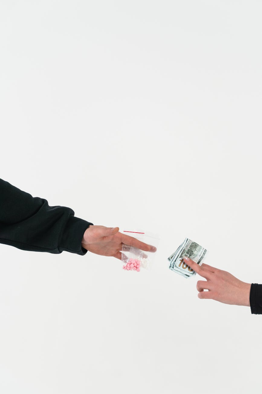 person trading money for drugs