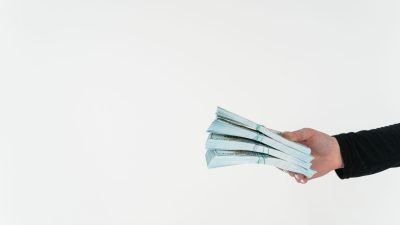 a person holding bundles of cash money