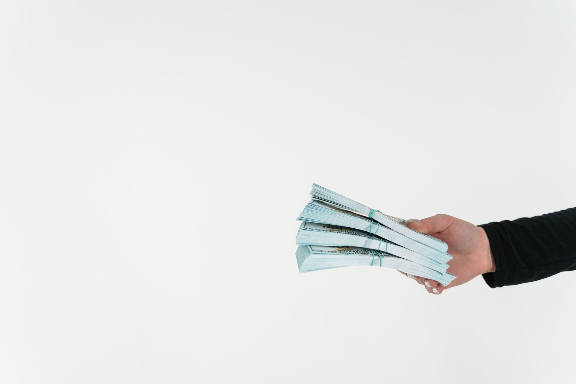 a person holding bundles of cash money