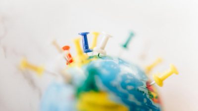 a globe with push pins