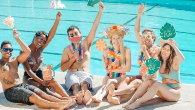people having fun while sitting on the poolside