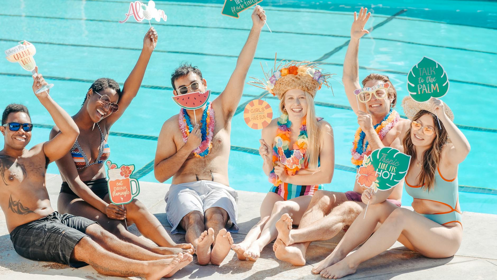 people having fun while sitting on the poolside