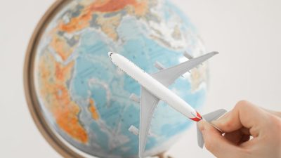 close up shot of a person holding an airplane toy