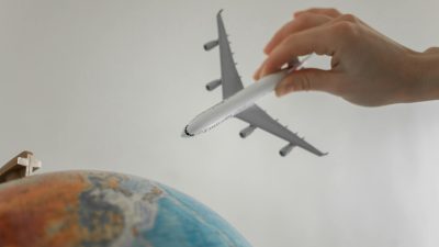 close up shot of a person holding an airplane toy