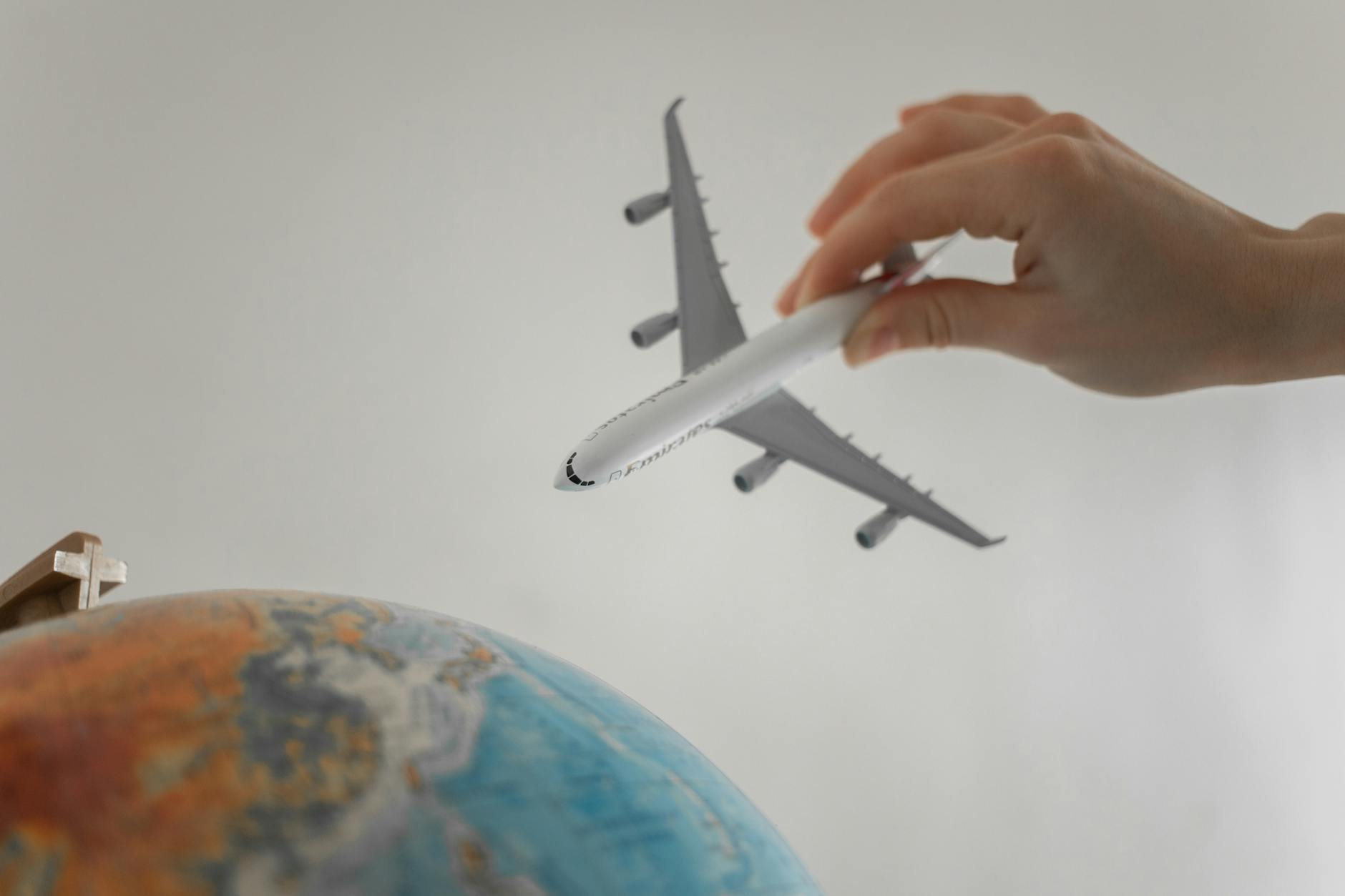 close up shot of a person holding an airplane toy