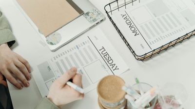 person writing on a paper