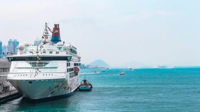 white cruise ship docking in port