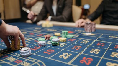 a person placing bets on roulette table