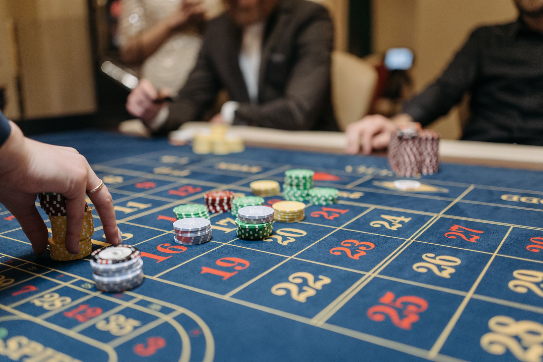 a person placing bets on roulette table
