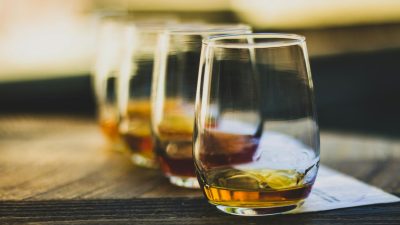 close up of drinking glasses with whisky