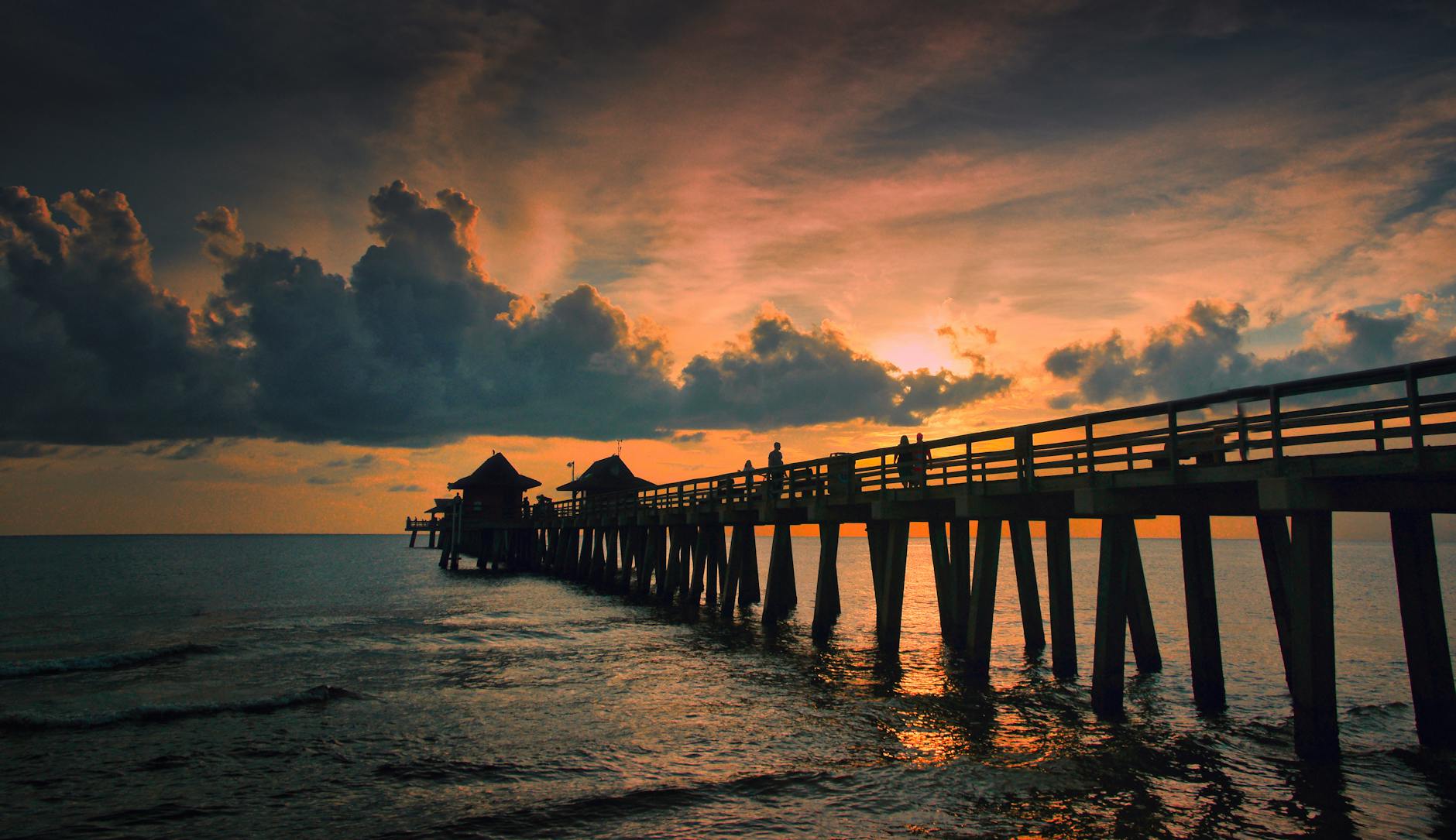 wooden dock on the seashore during dawn