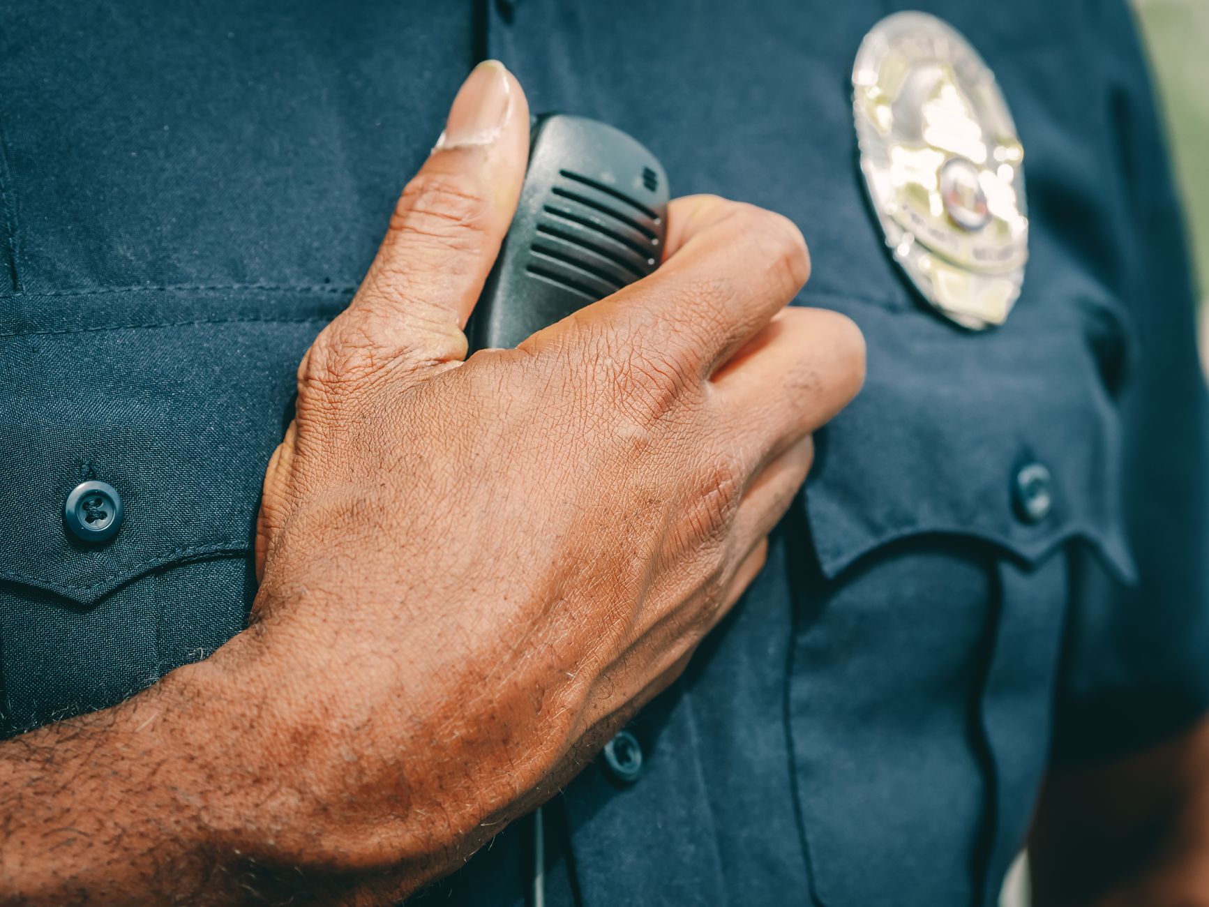 a police office holding black radio