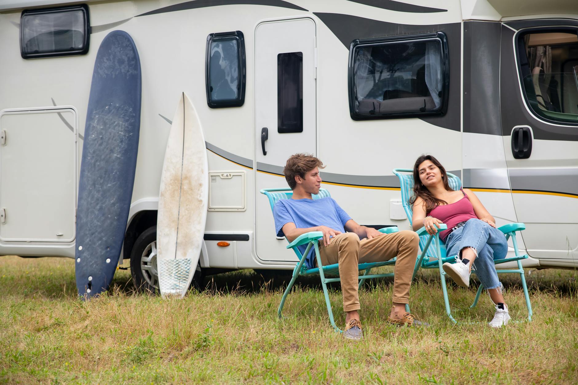 photo of a couple sitting on blue camping chairs