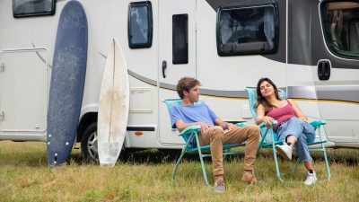 photo of a couple sitting on blue camping chairs