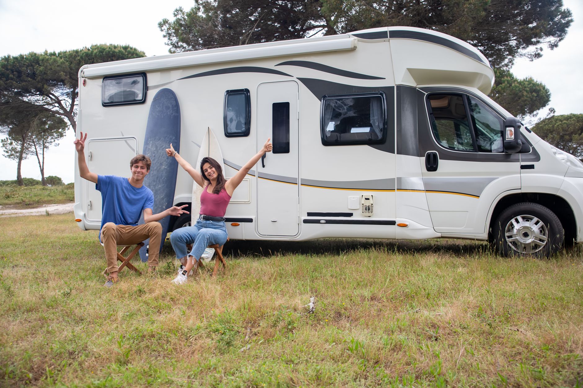 couple sitting outside the rv