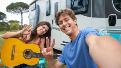 woman and man sitting with a guitar
