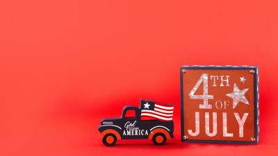car figurine and a board on red background