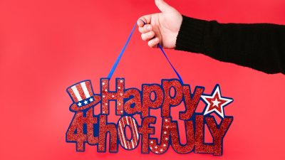 a person holding a banner happy fourth of july