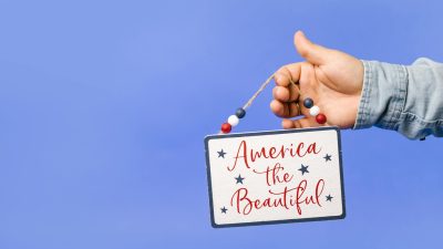 a person holding a hanging decoration