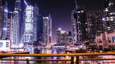boats on body of water surrounded by high rise buildings