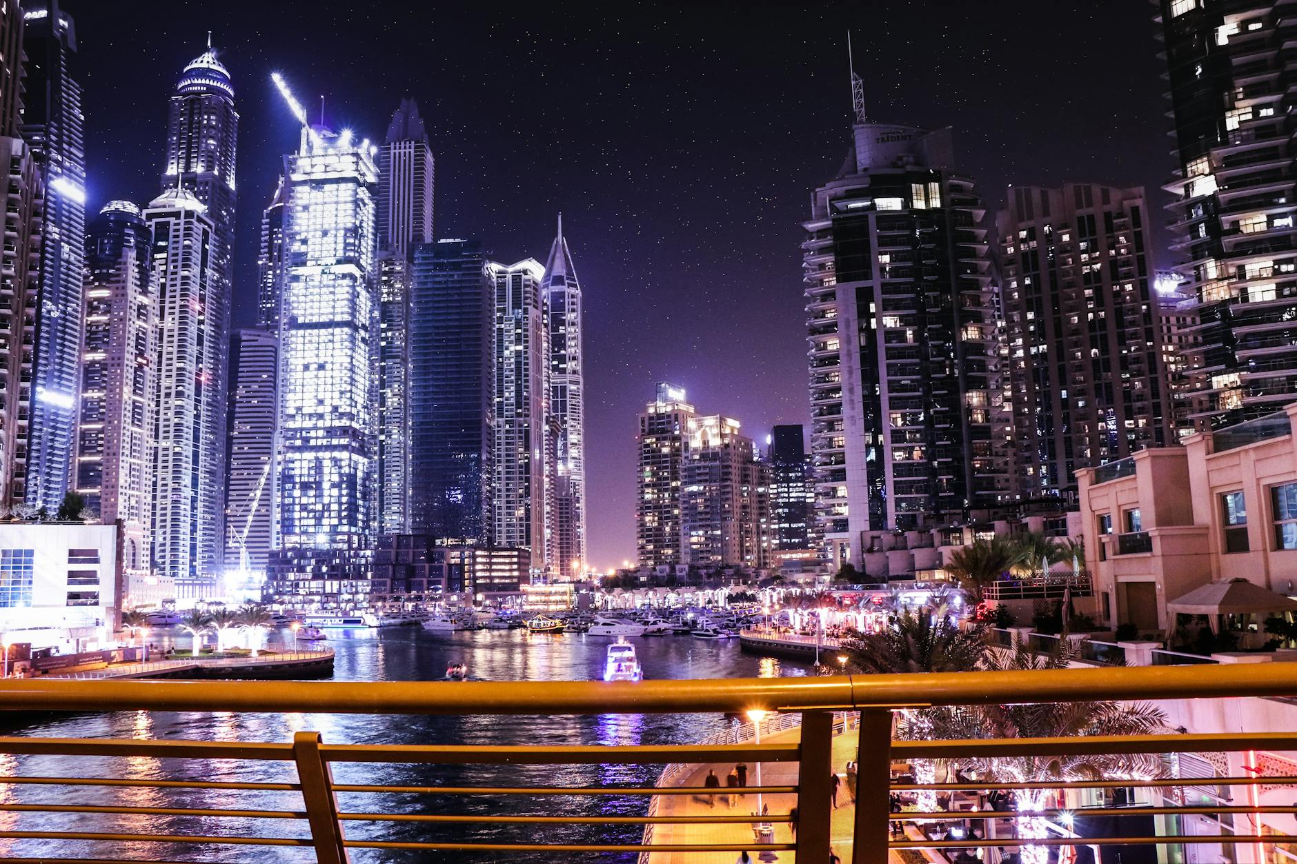 boats on body of water surrounded by high rise buildings