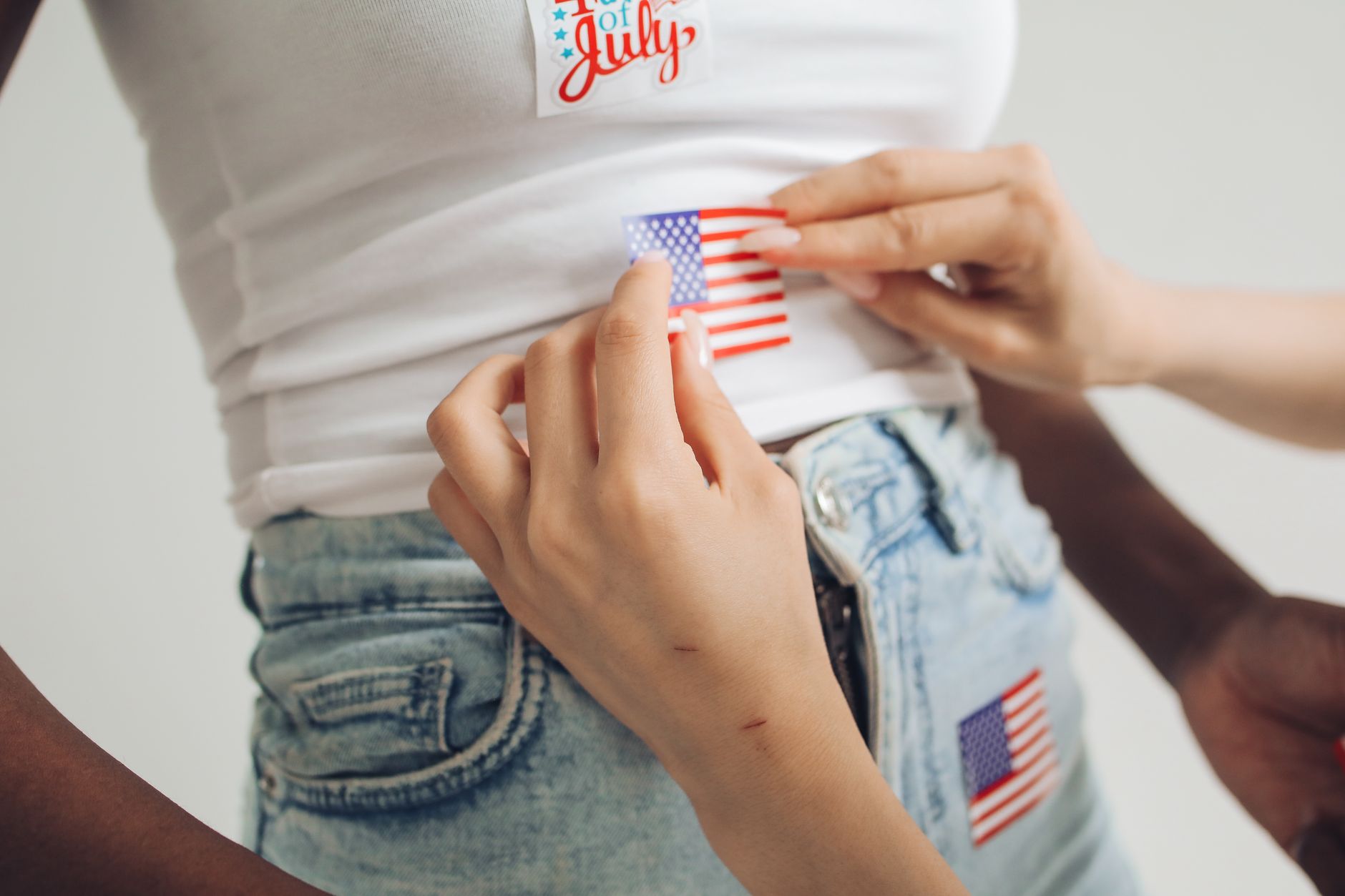 person sticking a sticker on a person s shirt