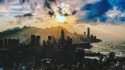 bird s eye view of city near ocean during sunset