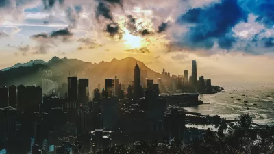 bird s eye view of city near ocean during sunset