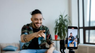 a man doing blogging using smartphone